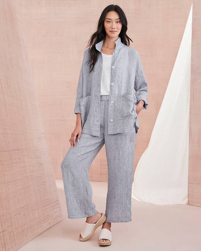 A woman in a gray textured organic-linen jacket and pants. Browse the Eileen Fisher shop.